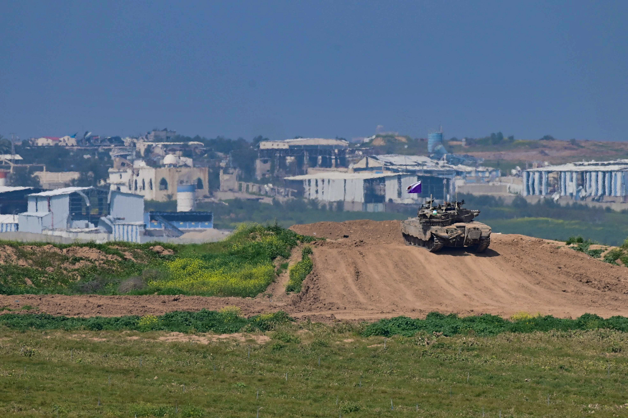 Israeli military vehicles seen near the Israeli-Gaza fence, February 28, 2024. (Tomer Neuberg/Flash90)
