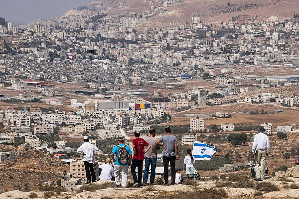 Israeli settlers attempt to establish a new outpost in response to the killing of two settlers the night before, near the illegal settlement of Itamar, occupied West Bank, October 2, 2015. (Yotam Ronen/Activestills)