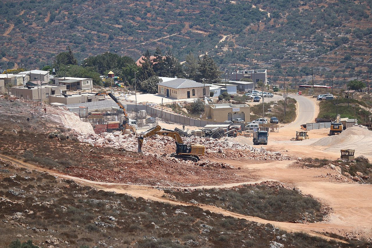 Israeli bulldozers expand the West Bank Jewish-only settlement of Nofei Nehemia in the Salfit District on private Palestinian land, which was expropriated by Israel and declared "state" (public) land, according to the owners, August 13, 2020. (Ahmad Al-Bazz/Activestills)