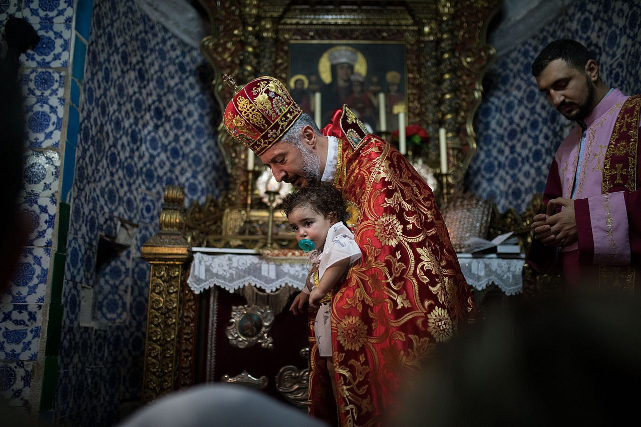 Armenians attend a Baptism Ceremony the St. Stephen North Chapel in St James Cathedral in the Armenian Quarter, in the Old City of Jerusalem, October 8, 2018. (Hadas Parush/Flash90)