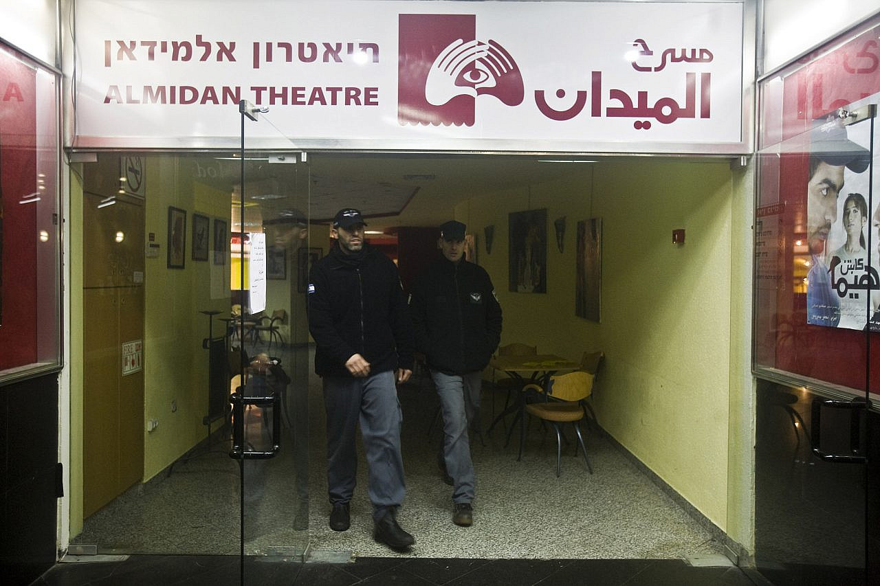 Police officers walk out of Al-Midan Theater in Haifa after Israeli Police Commissioner Dudi Cohen ordered the cancellation of a memorial event for Popular Front for the Liberation of Palestine (PFLP) leader George Habash, February 1, 2009. (Oren Ziv/Activestills)