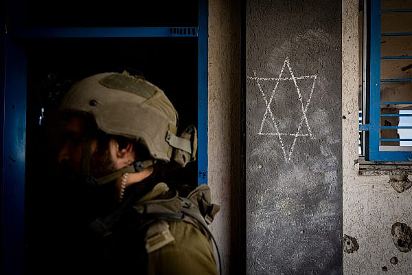 A Star of David is seen carved into a wall as Israeli soldiers operate inside Al-Shati refugee camp, northern Gaza Strip, November 16, 2023. (Yonatan Sindel/Flash90)