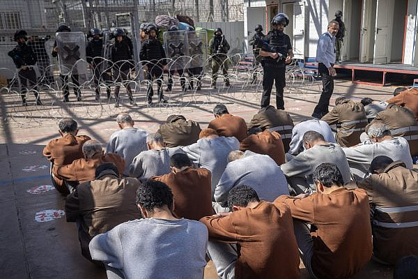 Prisoners seen at a courtyard in a prison in southern Israel, February 14, 2024. (Chaim Goldberg/Flash90)