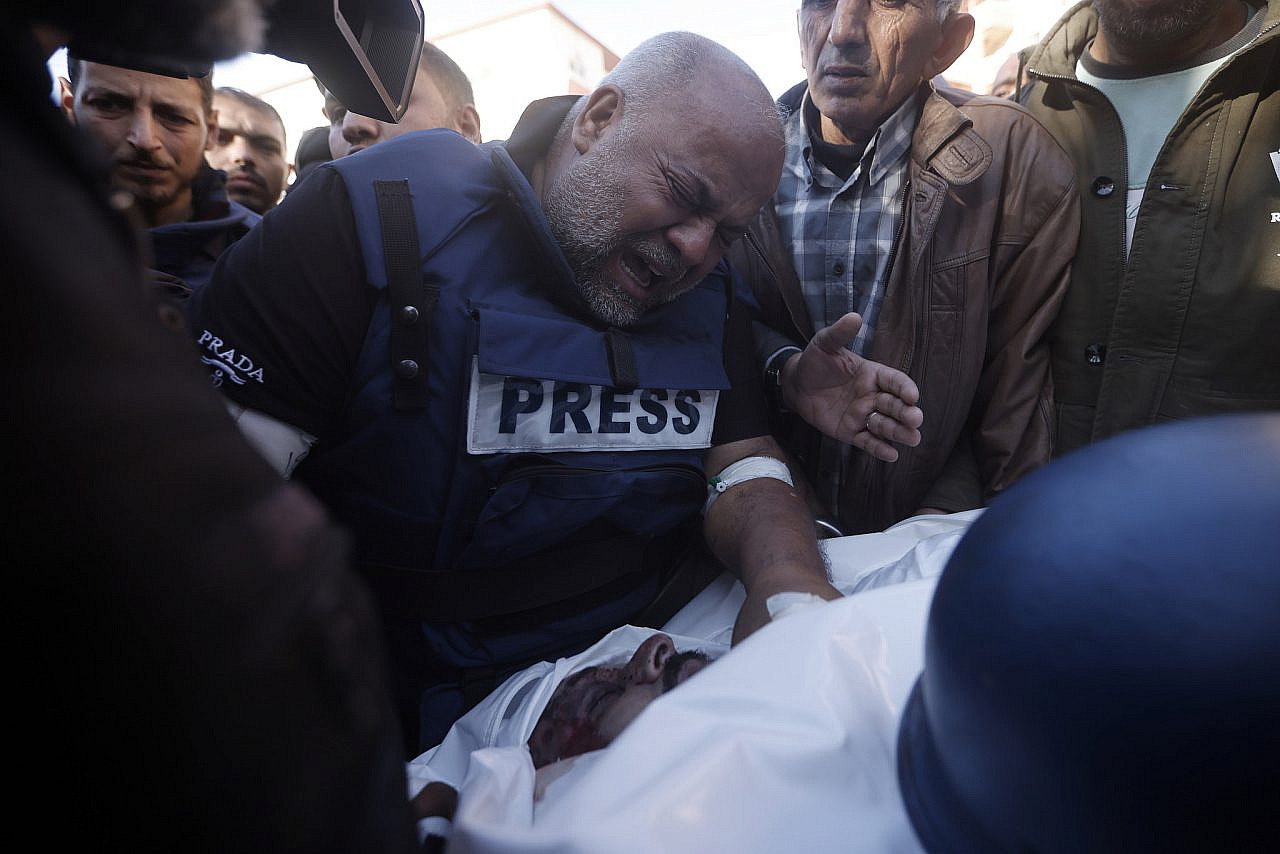 Al Jazeera correspondent Wael Dahdouh mourns over the body of Al Jazeera cameraman Samer Abu Daqqa, who was killed by an Israeli drone strike, during his funeral in Khan Younis, southern Gaza Strip, December 16, 2023. (AP Photo/Mohammed Dahman)
