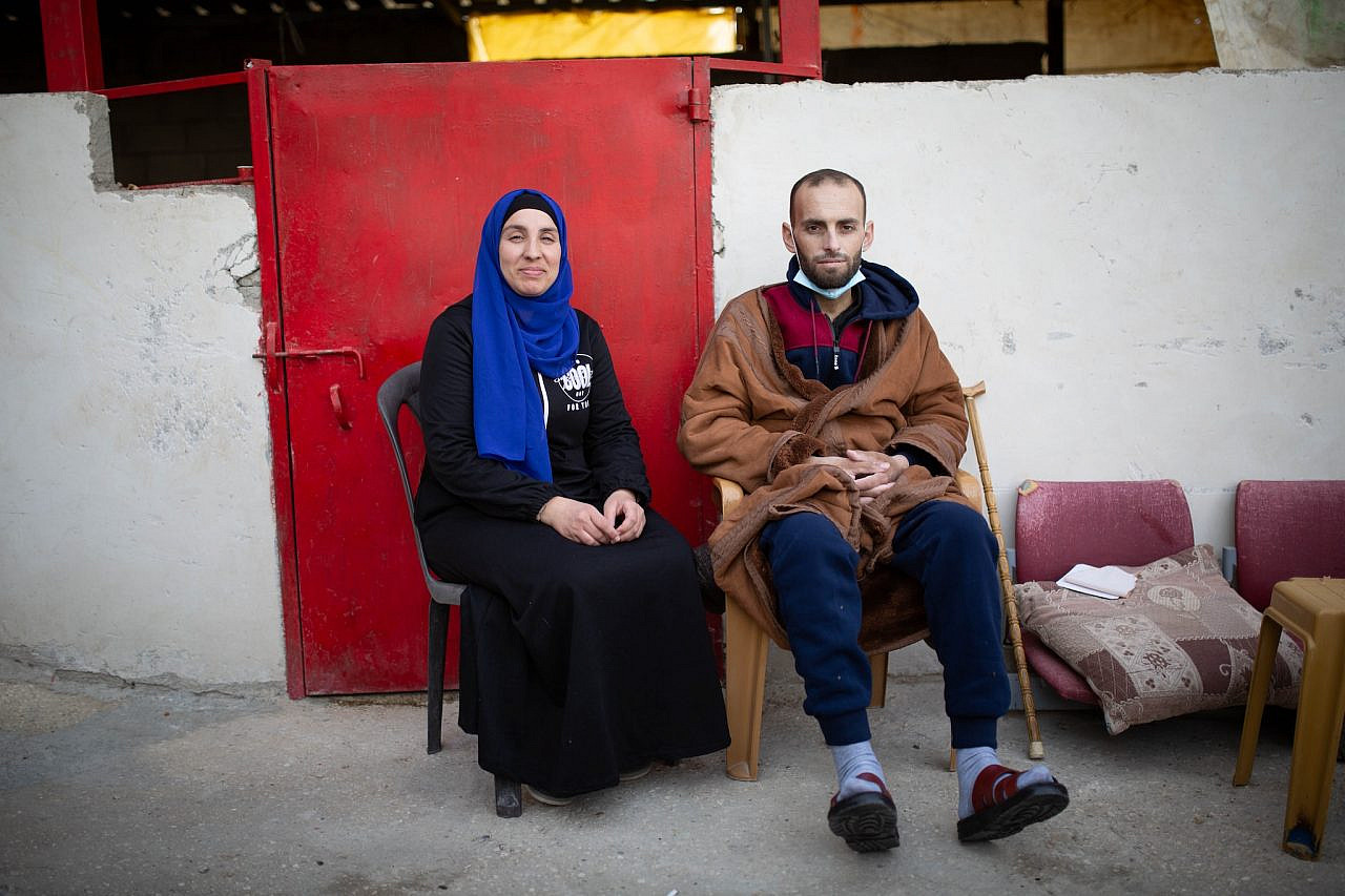 Shoug and Zakariyah sitting outside their home in At-Tuwani the week that Zakariyah was released from the hospital, January 2024 (Emily Glick)