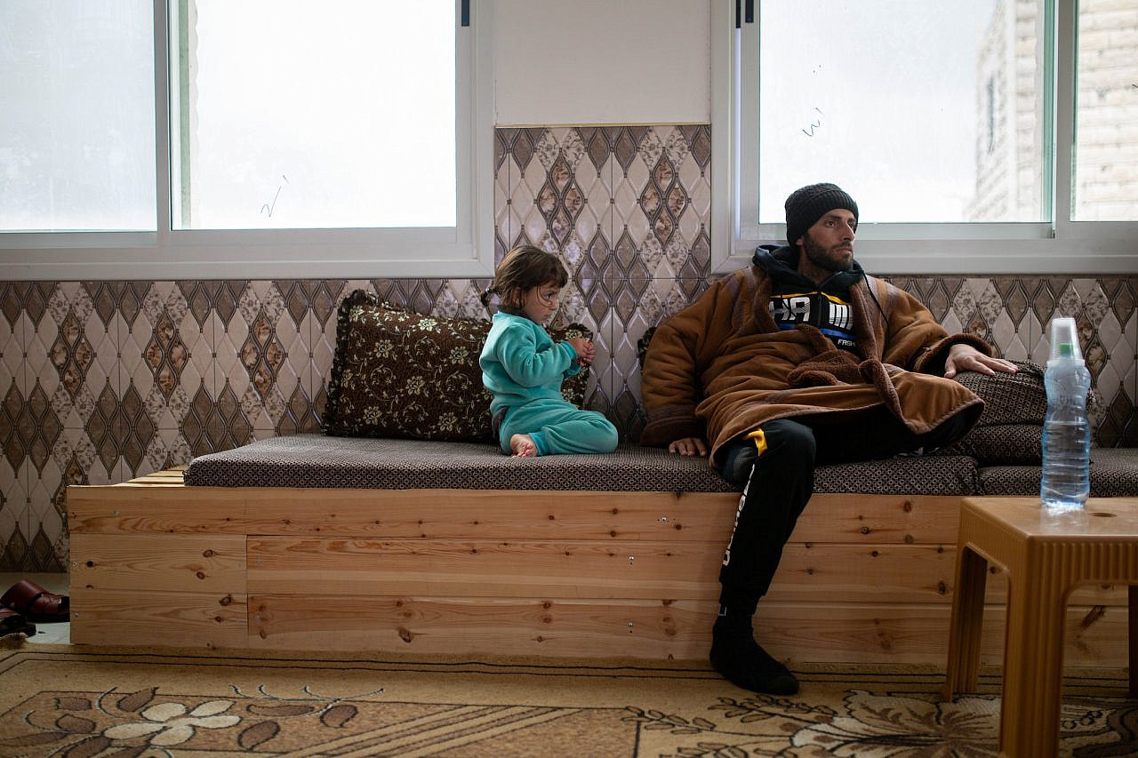 Zakariyah and his daughter Aretha in their home in At-Tuwani, March 2024 (Emily Glick)