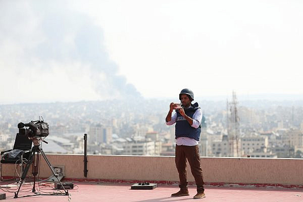 A Palestinian journalist covering the war from above the Tabaa Tower, Gaza Strip, October 23, 2023. (Mohammed Zaanoun)