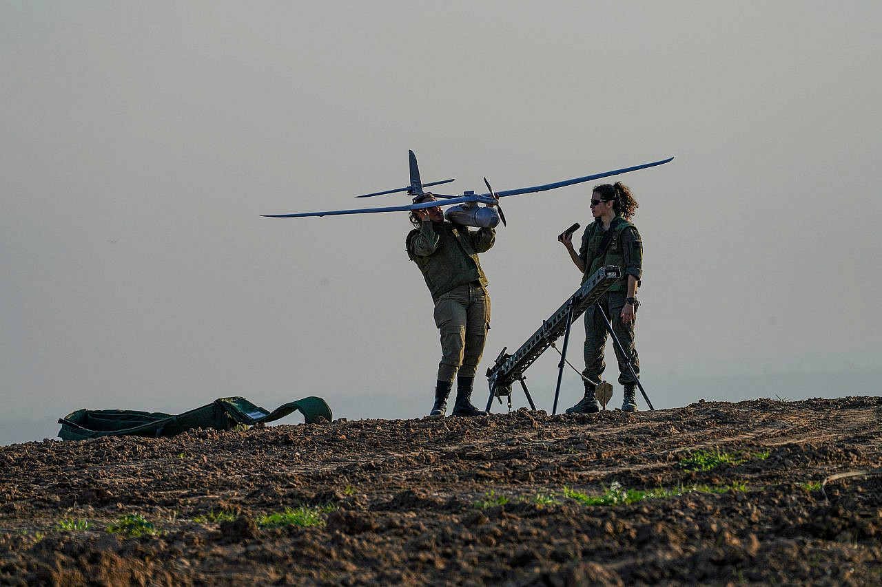 An Israeli soldier holds a drone near the Gaza fence on January 6, 2024. (Flash90)