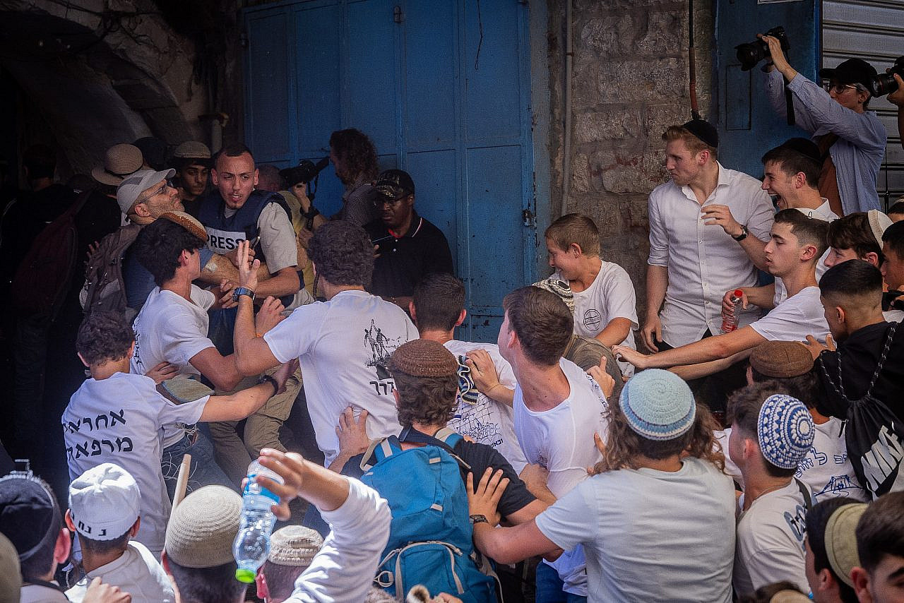 Israeli youth attack a group of mostly Palestinian journalists at Damascus Gate in Jerusalem's Old City ahead of the Flag March, June 5, 2024. (Chaim Goldberg/Flash90)