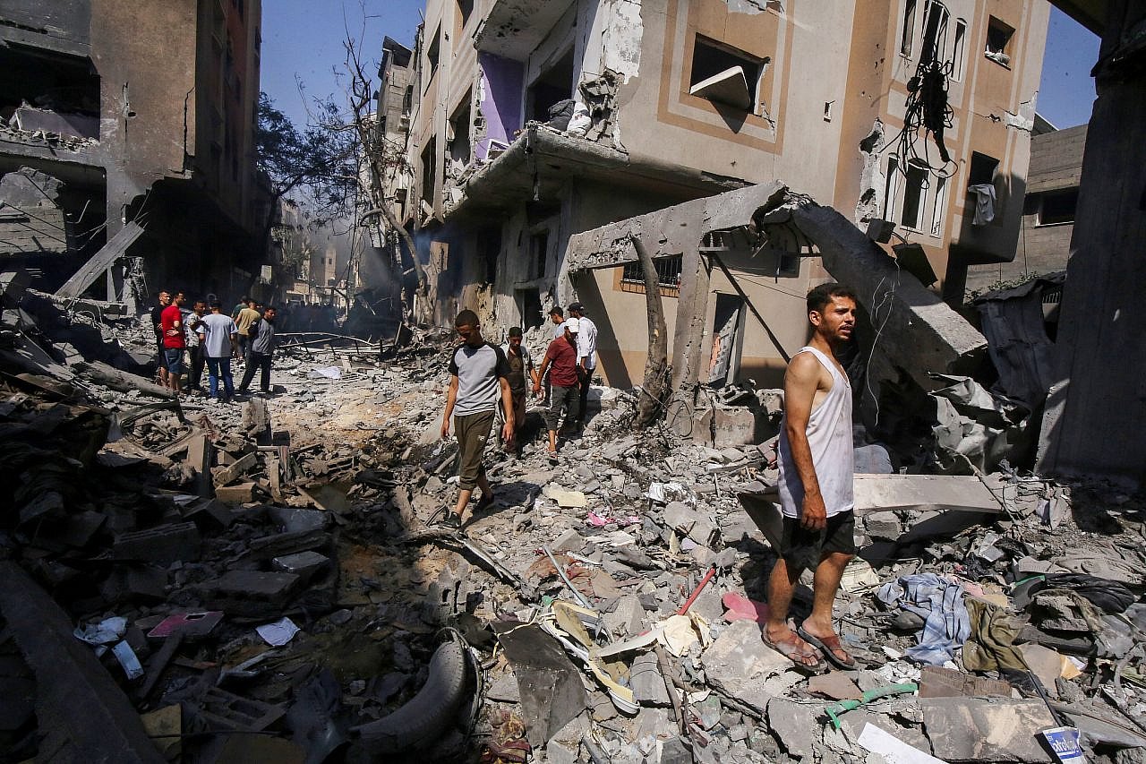 Palestinians observe the destruction caused by an Israeli military operation in Nuseirat camp in the central Gaza Strip, June 8, 2024. (Khaled Ali/Flash90)