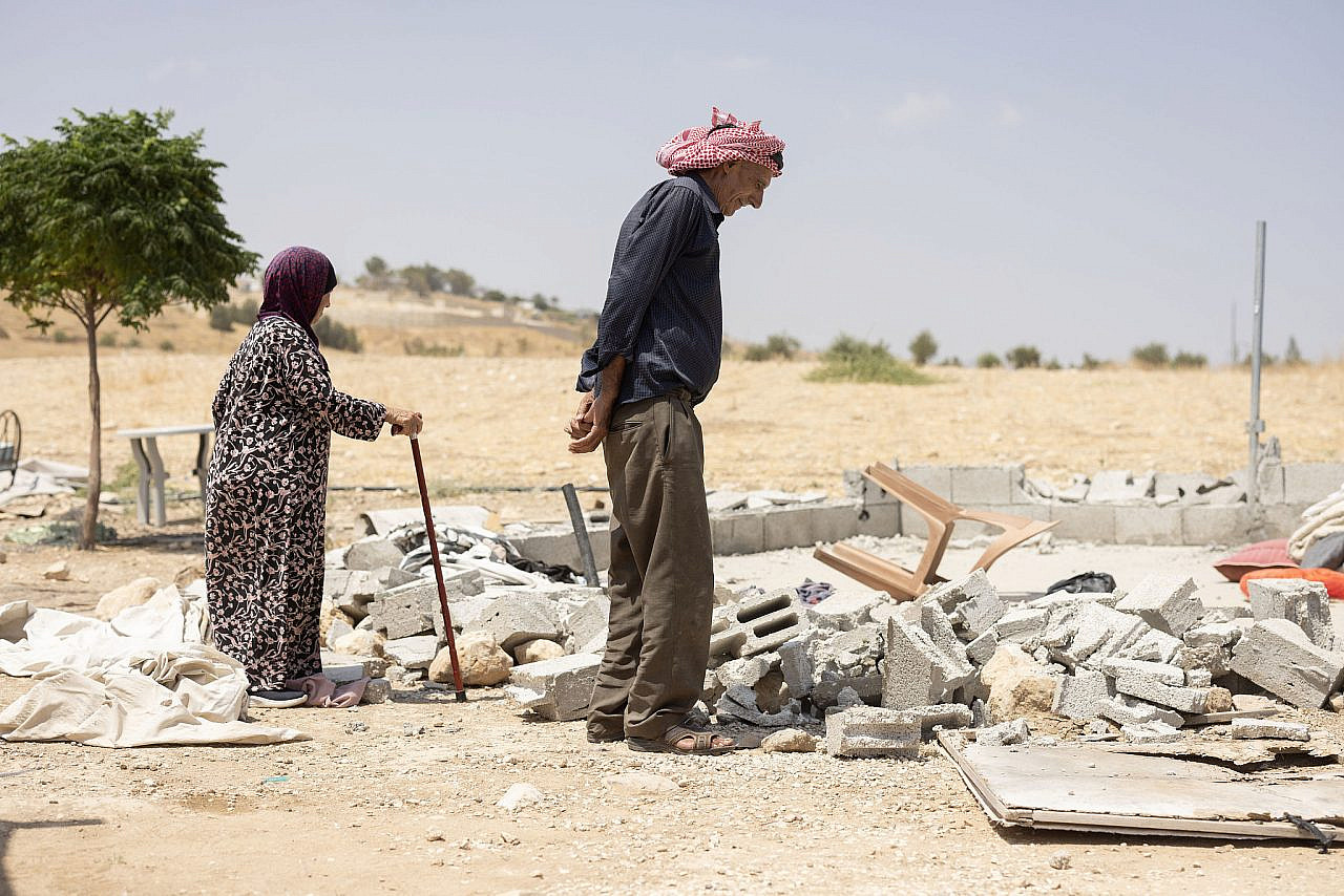 Former residents of the village of Khalet Khader inspect the destruction left by Israeli settlers, Jordan Valley, occupied West Bank. (Oren Ziv)