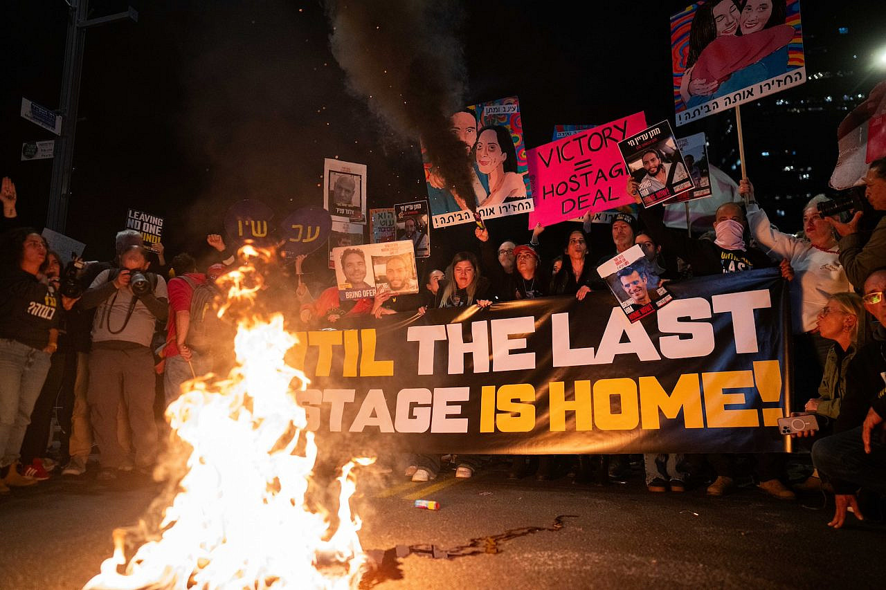 Demonstrators protest calling for the release of Israeli hostages held in Gaza, outside Hakirya Base in Tel Aviv, January 18, 2025. (Erik Marmor/Flash90)