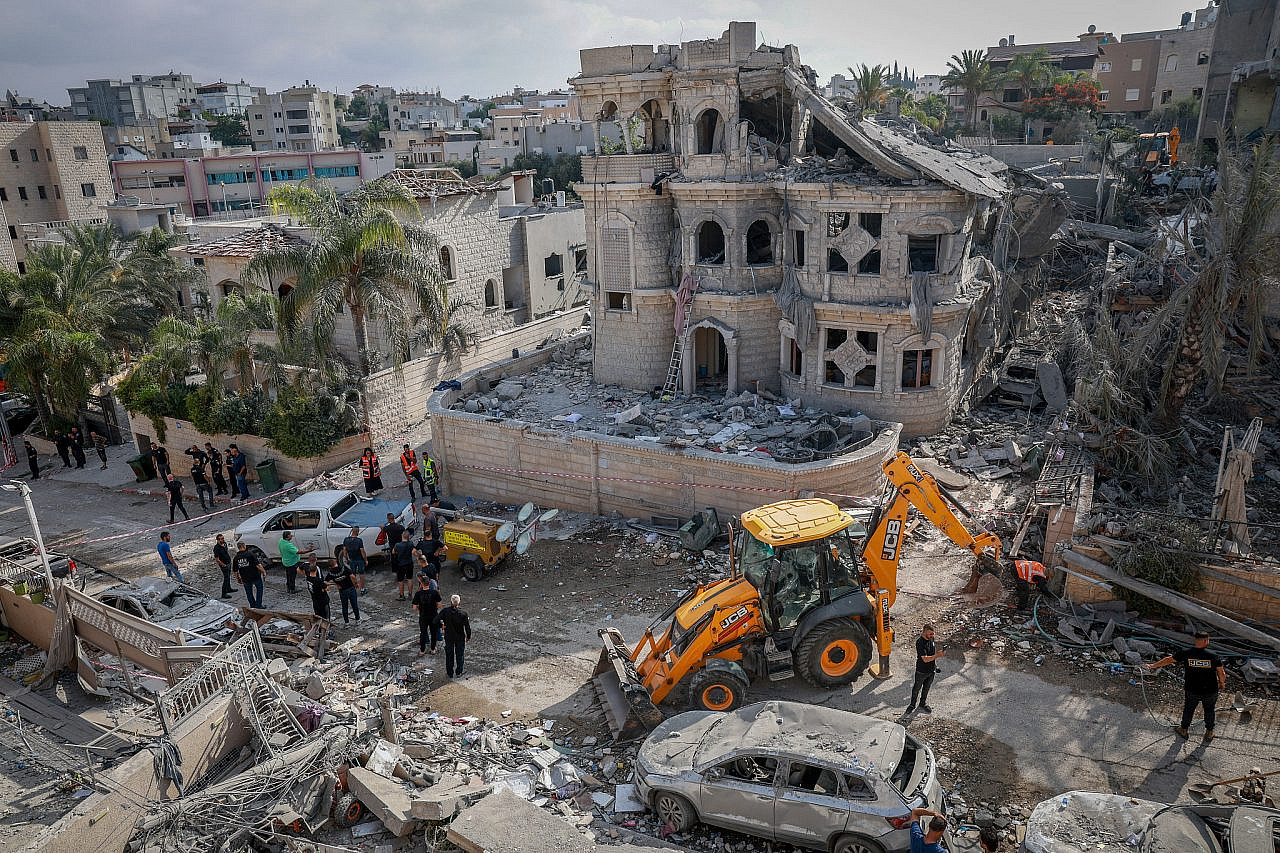 Israeli security and rescue forces at the scene where a ballistic missile fired from Iran hit and caused damage in Tamra, June 15, 2025. (David Cohen/Flash90)