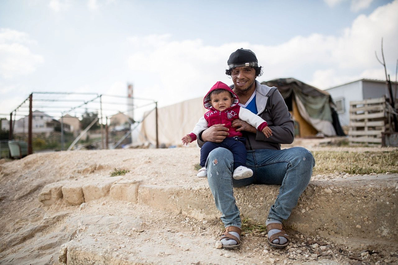 Awdah Hathaleen and his eldest son, Watan, in Umm Al-Khair, the West Bank, March 2021. (Emily Glick)