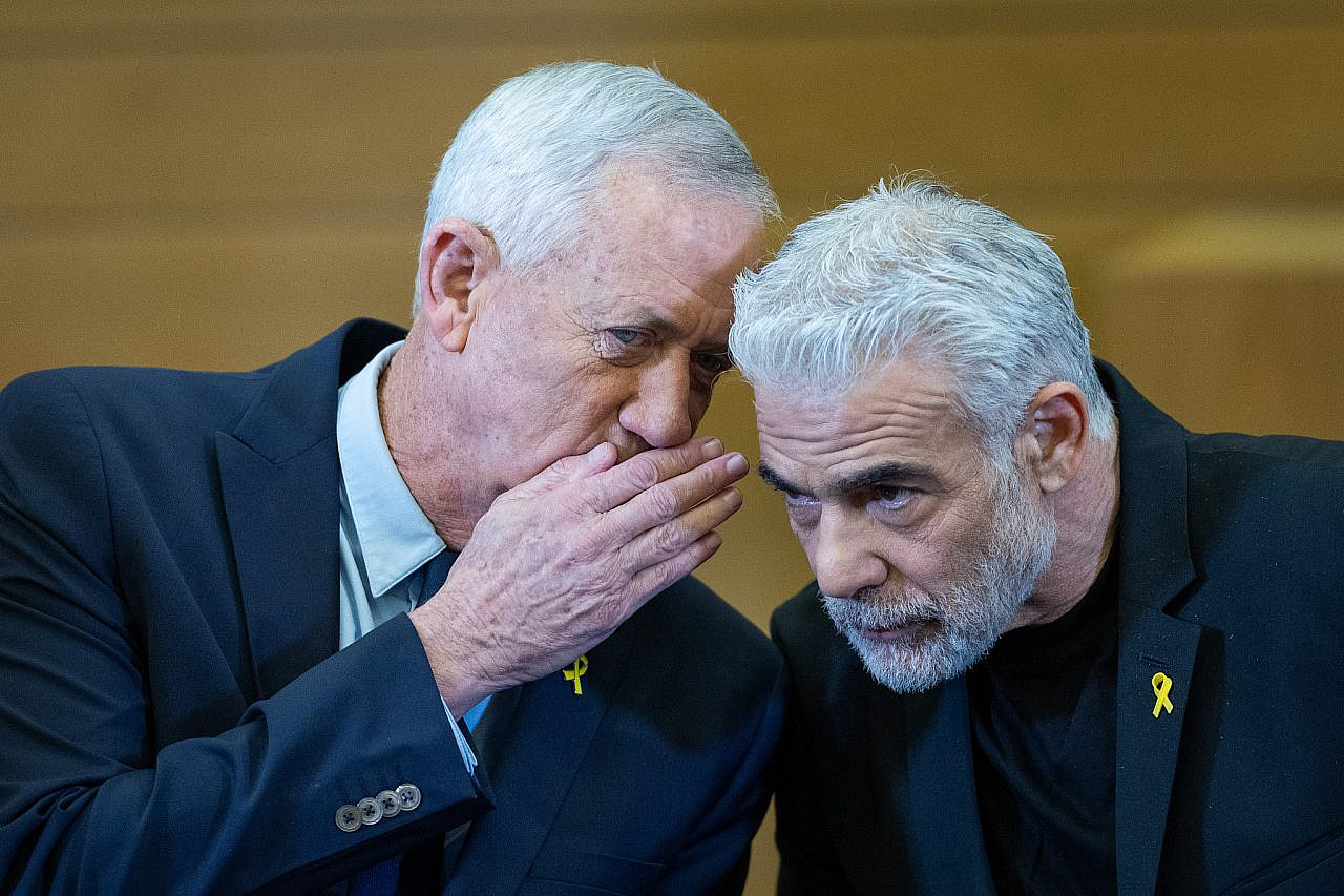 National Unity head Benny Gantz speaks to Yesh Atid head Yair Lapid during a joint press conference at the Knesset in Jerusalem, November 6, 2024. (Yonatan Sindel/Flash90)