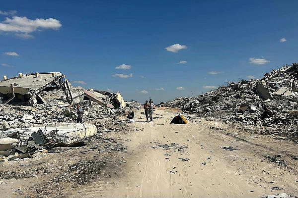 The ruins of the author's home, on the right side of the street, in Khan Younis, Gaza, October 14, 2025. (Courtesy)