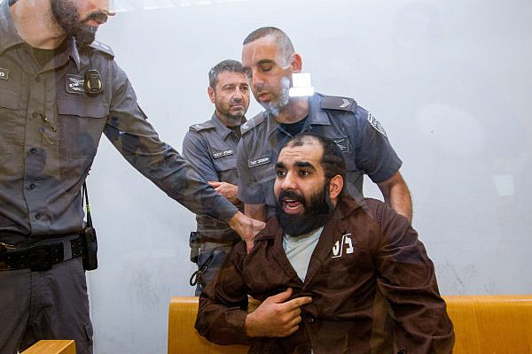 A Palestinian man accused of taking part in a lynching during a 2021 riot in Akka, at a court hearing in Haifa, July 28, 2022. (Flash90)
