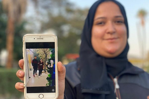 Laila Al-Helu holds a photo of her and her brother Shawqi. (Ahmed Ahmed)