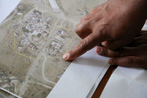 Khalil Al-Hathalin, a representative of Umm Al-Khair’s residents, indicates on a map the area of the village threatened by Israeli demolition orders, in Umm Al-Khair, Masafer Yatta, occupied West Bank, October 29, 2025. (Mosab Shawer/Activestills)