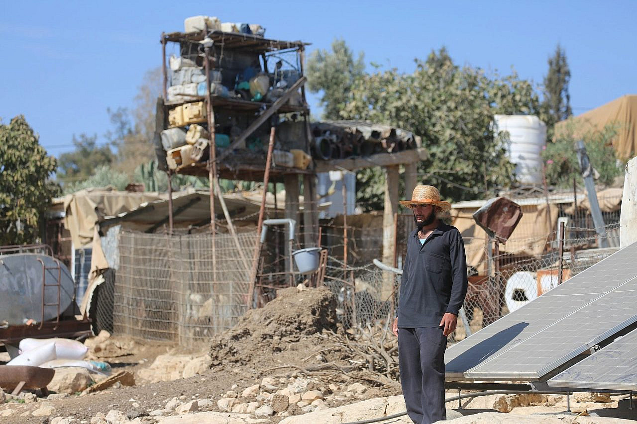 Palestinian man stands beside buildings buildings set to be demolished by Israeli authorities, in Umm Al-Khair, Masafer Yatta, occupied West Bank, October 29, 2025. (Mosab Shawer/Activestills)