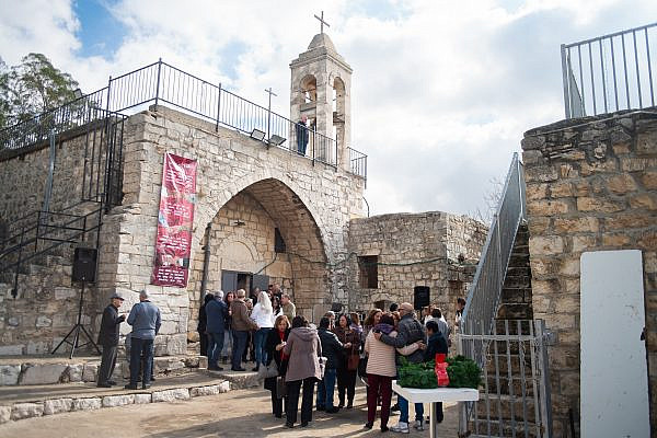 People gather near the entrance to the the church at the Christmas market in Bir'im, Dec. 13, 2025. (Anna Maria Hawa)