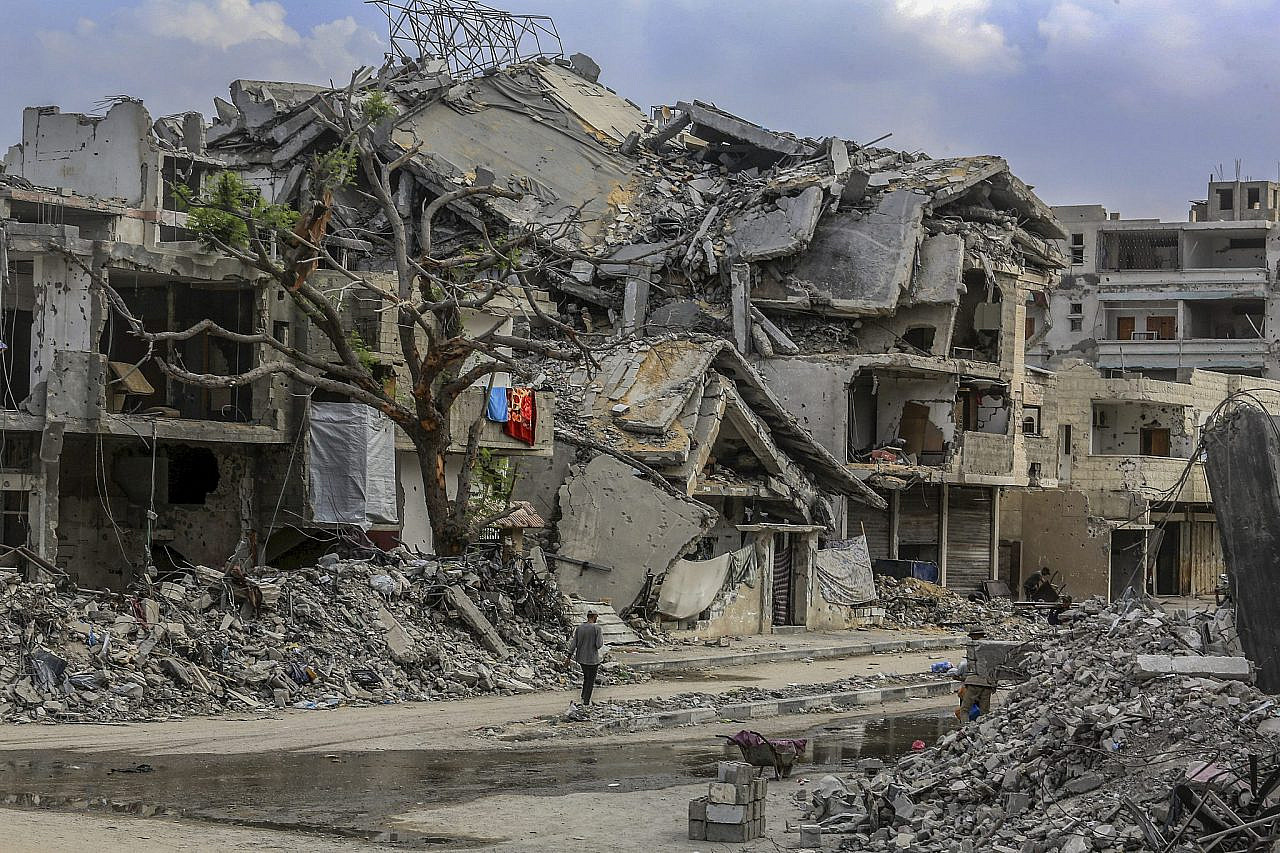 Palestinians walk among destroyed buildings in the Tel Al-Hawa neighborhood of Gaza City, norther Gaza Strip, November 14, 2025. (Abed Rahim Khatib/Flash90)