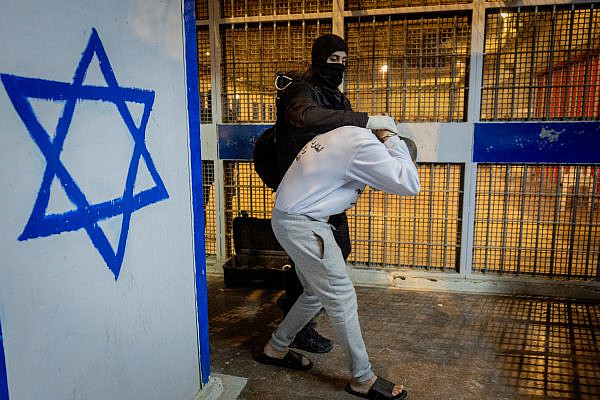 Israel Prison Service officers prepare Palestinian prisoners for release as part of a hostage deal between Israel and Hamas, at Ketziot Prison in southern Israel, February 26, 2025. (Chaim Goldberg/Flash90)