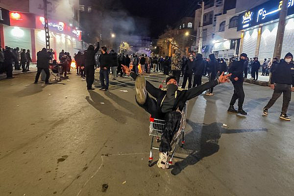 Iranians gather while blocking a street during a protest in Kermanshah, Iran, January 8, 2026. (Kamran / Middle East Images / AFP via Getty Images)