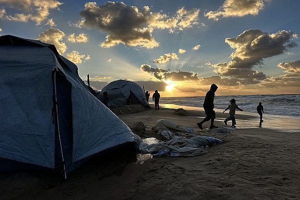 Palestinian children play near displaced families' tents, on the beach in al-Mawasi, Khan Younis, Gaza Strip, December 28, 2025. (Doaa Albaz/Activestills)