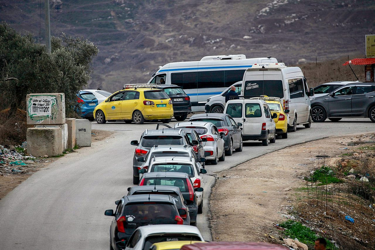 Palestinians wait in traffic at a checkpoint south of Nablus in the occupied West Bank, November 29, 2024. (Nasser Ishtayeh/Flash90)