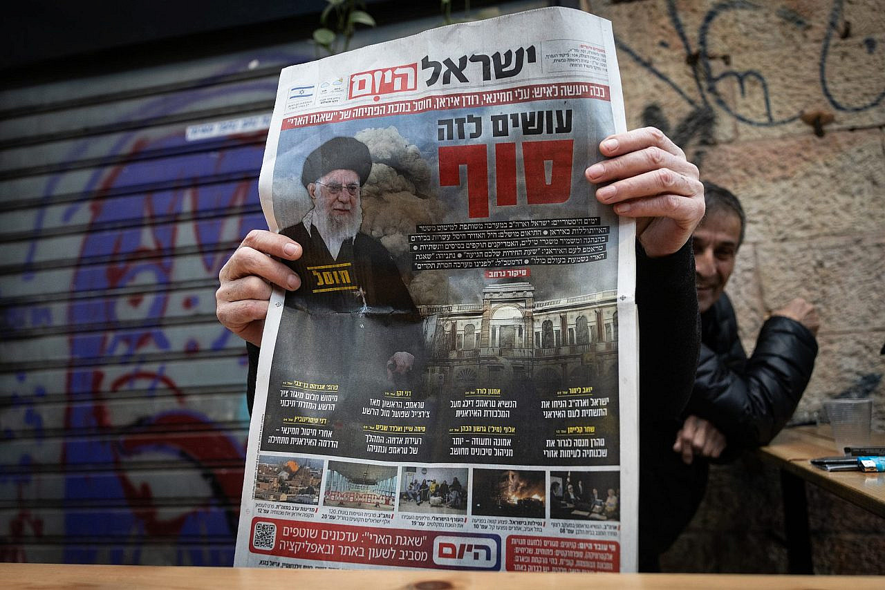 A man holds a copy of the Hebrew daily newspaper Israel Hayom at the Mahane Yehuda Market in Jerusalem, featuring on its front page Iran’s Supreme Leader Ali Khamenei, who was assassinated in an Israeli airstrike, March 1, 2026. (Yonatan Sindel/Flash90)
