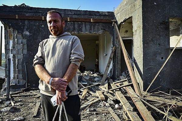 A Palestinian man inspects the damage after a missile fired from Iran struck the Palestinian town of Zarzir, northern Israel, March 13, 2026. (Michael Giladi/Flash90)