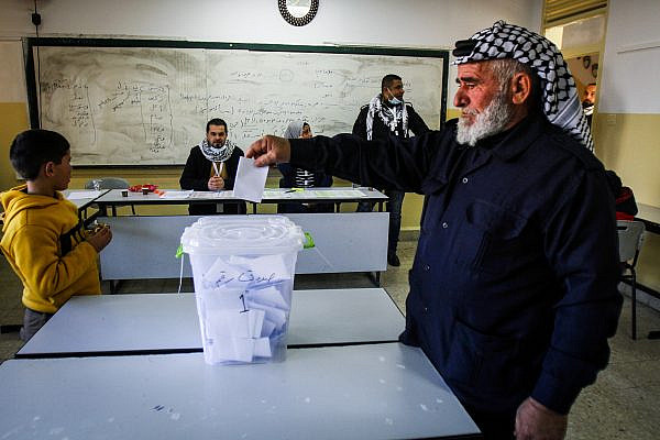 A Palestinian man casts his ballot during local elections, on the outskirts of the occupied West Bank city of Nablus, January 23, 2021. (Nasser Ishtayeh/Flash90)