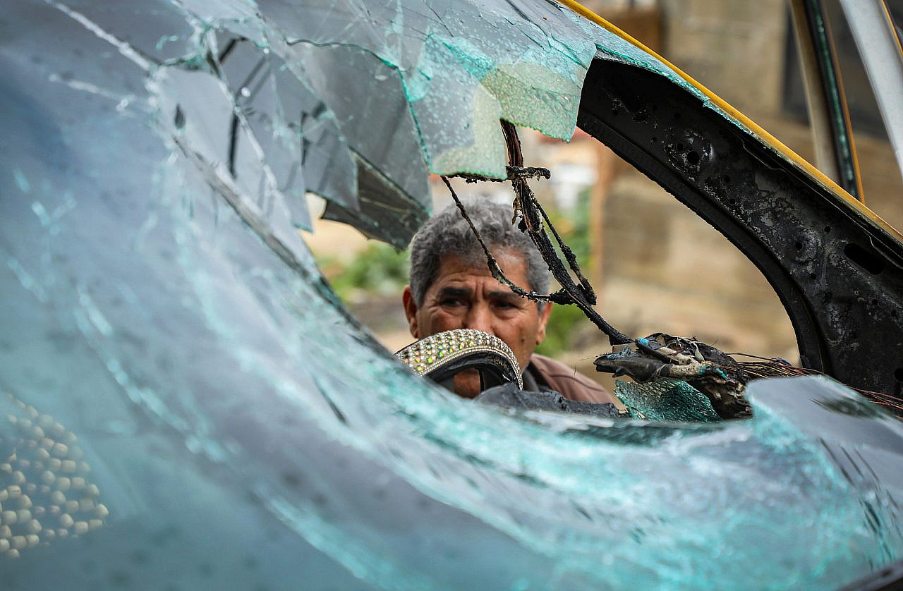 Palestinians inspect damage to vehicles and homes following an attack by Israeli settlers on the village of Fanduqmiya, south of Jenin in the occupied West Bank, March 22, 2026. (Nasser Ishtayeh/Flash90)