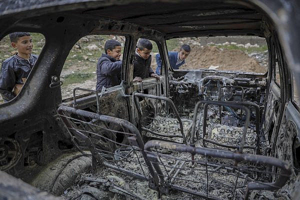 Palestinians inspect the damage caused during overnight attacks by Israeli settlers near Al-Arroub refugee camp in Hebron, March 30, 2026. (Wisam Hashlamoun/Flash90)