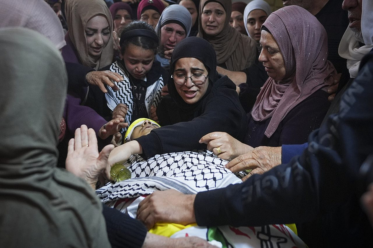 Palestinians attend the funeral of 14-year-old Aws Hamdi Al-Naasan and 32-year-old Jihad Marzouq Abu Naiem, who were killed by Israeli settler fire, in Al-Mughayyir, east of Ramallah, occupied West Bank, April 22, 2026. (Flash90)