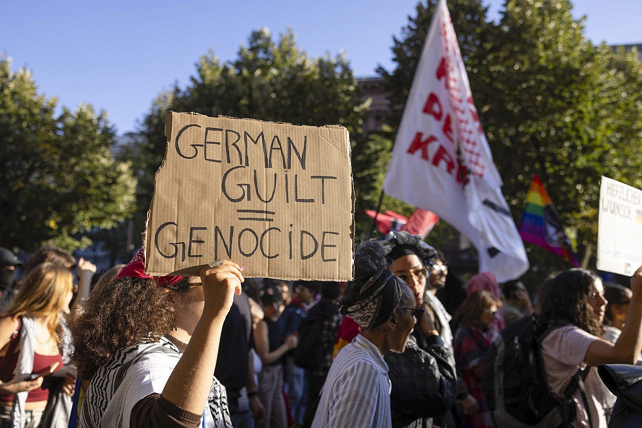 A protester holds a sign criticizing Germany’s complicity in the Gaza genocide, Berlin, Germany, September 27, 2025. (Oren Ziv/ActiveStills) A protester holds a sign criticizing Germany's complicity in the Gaza genocide, Berlin, Germany, September 27, 2025. (Oren Ziv/ActiveStills)