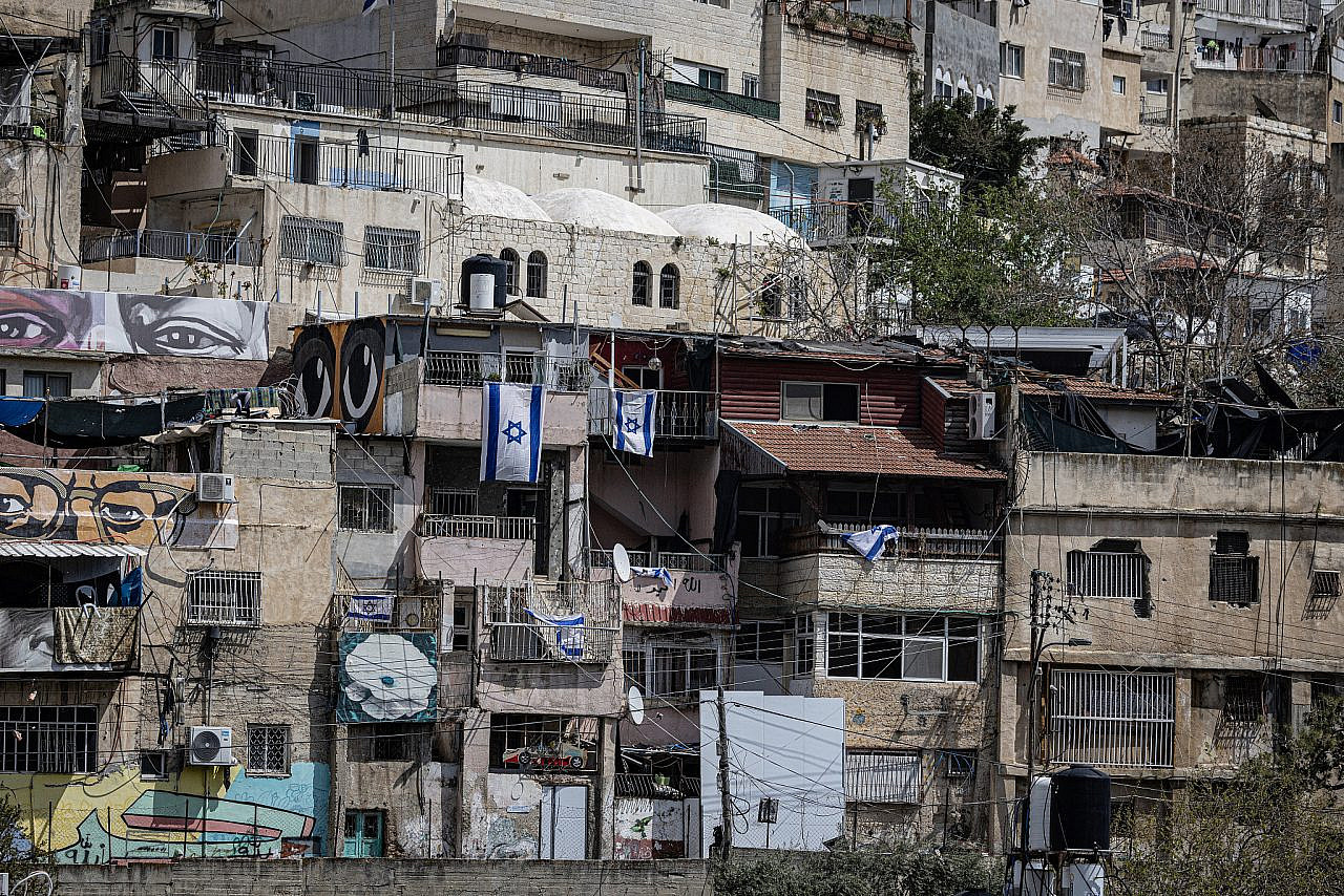 Israeli flags hang from the balconies of Palestinian homes taken over by Israeli settlers in Batan Al-Hawa, Silwan, occupied East Jerusalem. (Faiz Abu Rmeleh)