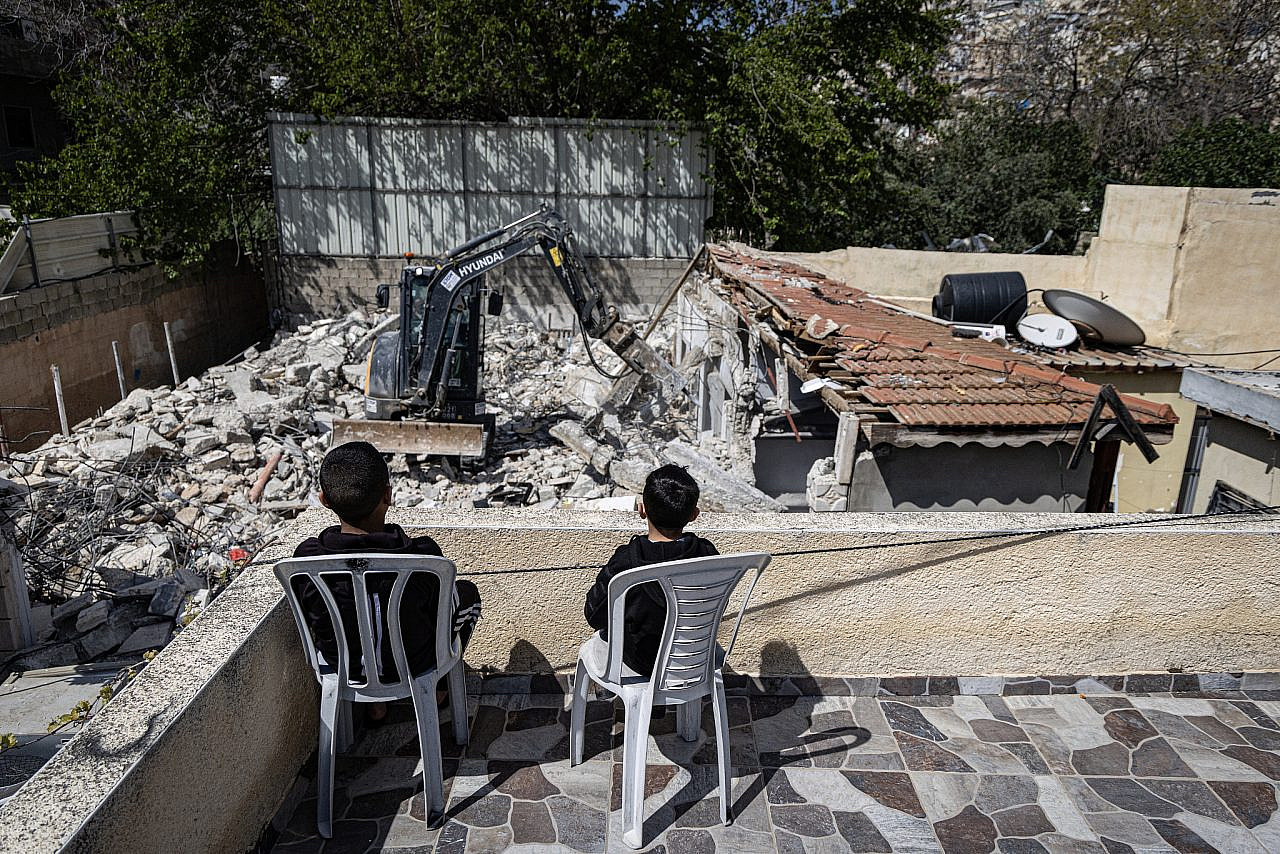 Children from the Odeh family watch a neighboring family demolish their own home in Al-Bustan, Silwan, occupied East Jerusalem. (Faiz Abu Rmeleh)