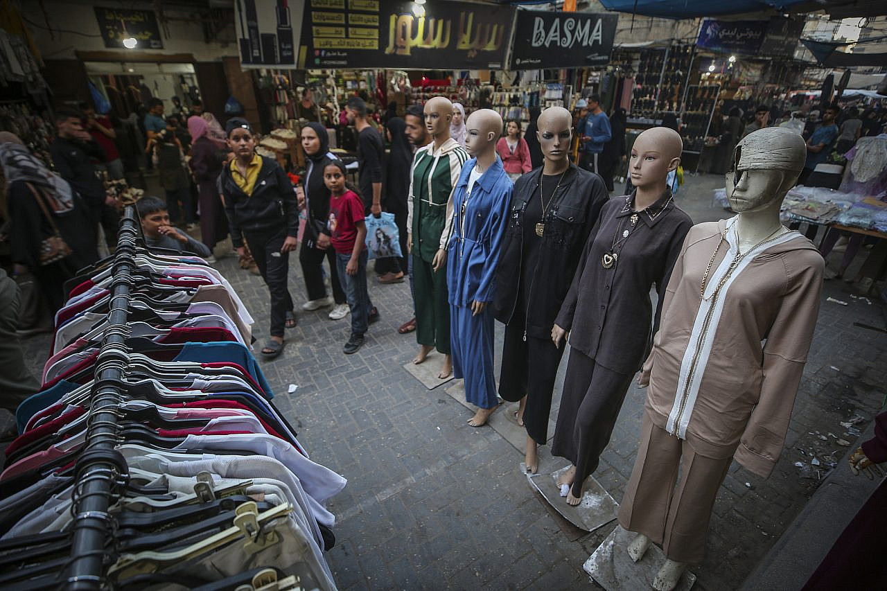 Palestinians shop at a market ahead of the Eid al-Adha festival, central Gaza Strip, May 24, 2026. (Ali Hassan/Flash90)