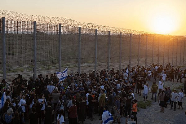 Right-wing Israeli activists gather near the Gaza perimeter fence, during the "March of the Thousands," July 19, 2026. (Oren Ziv)