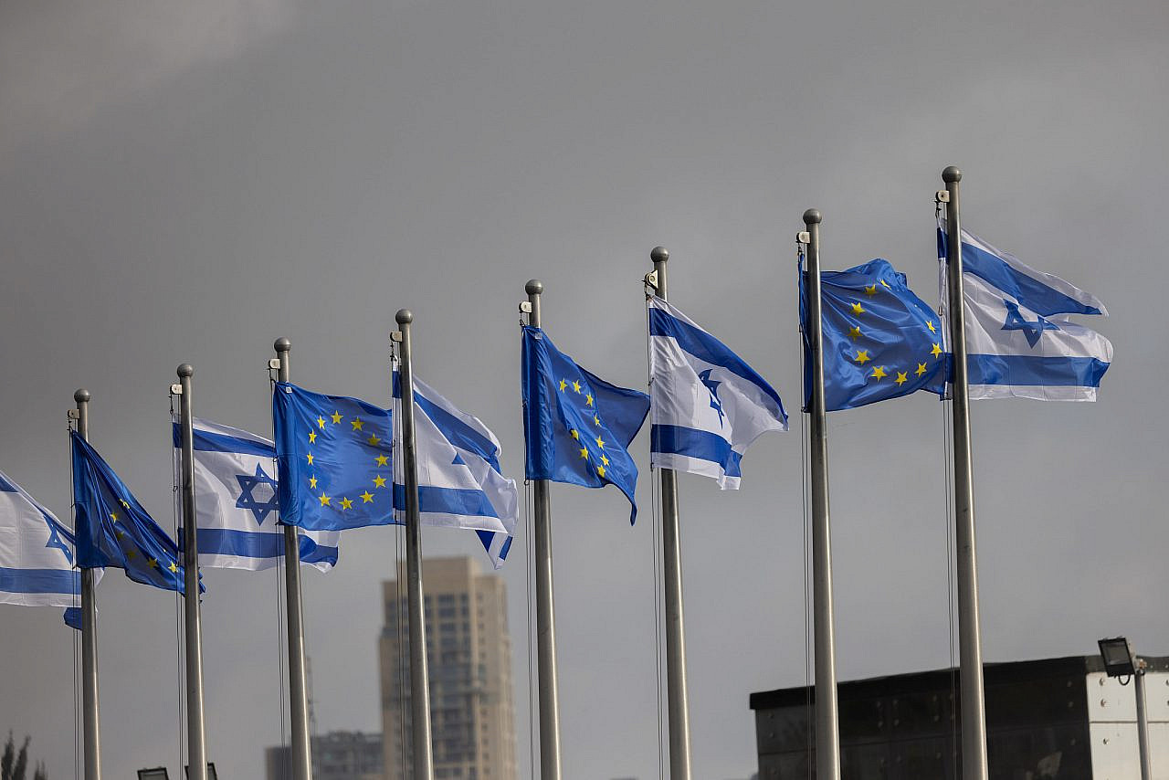 The Israeli and European flags outside the Israeli parliament during the official visit of president of the European Parliament Roberta Metsola, in Jerusalem, February 13, 2025. (Chaim Goldberg/Flash90)