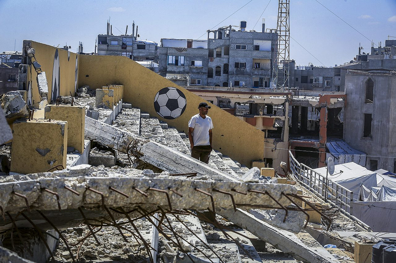 Displaced Palestinians take shelter in a tent camp established inside a football stadium damaged during the recent war in Khan Younis, southern Gaza Strip, June 13, 2026. (Abed Rahim Khatib/Flash90)