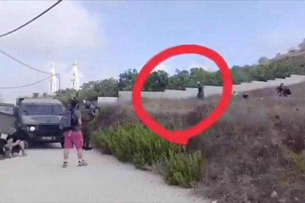 A screenshot from a video showing Farouk Ramadan (circled) walking unarmed toward Israeli soldiers before he is shot dead, in the village of Tel, occupied West Bank, July 24, 2026. (Used in accordance with Section 27A of the copyright law)