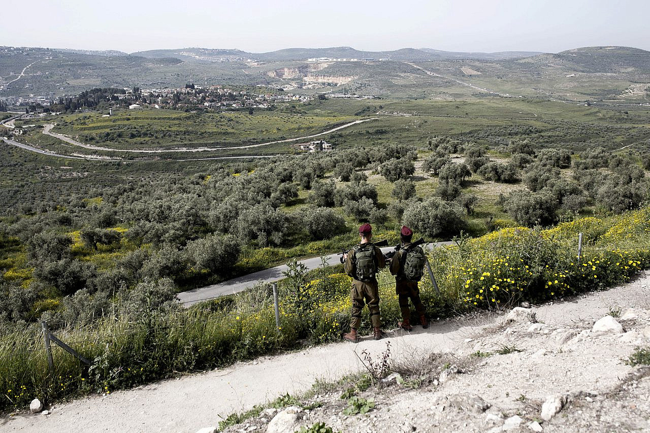 Israeli soldiers watch over the Roman remains in the Palestinian village of Sebastia, occupied West Bank, April 24, 2019. (Anne Paq/Activestills)