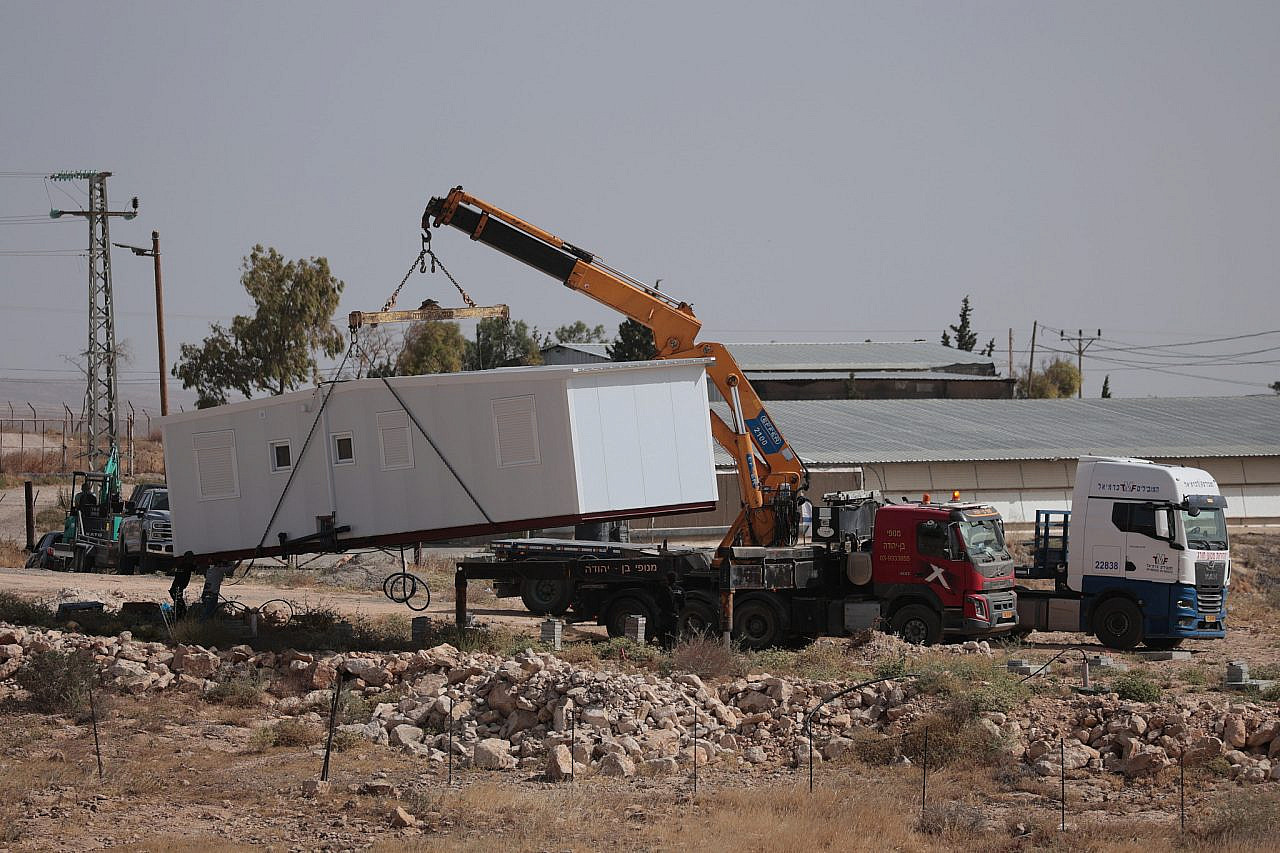 Israeli settlers install new mobile homes as part of an outpost expansion in Umm Al-Khair, Masafer Yatta, occupied West Bank, May 20, 2026. (Activestills/Mosab Shawer)