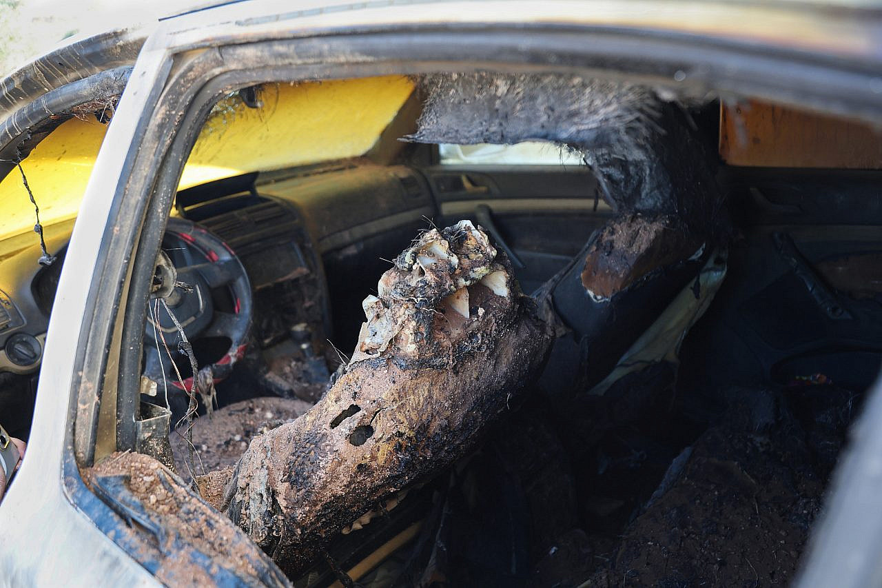 The remains of the author's burned out car after an attack by Israeli settlers the previous night in the village of At-Tuwani, Masafer Yatta, southern occupied West Bank, July 19, 2026. (Mosab Shawer/Activestills)