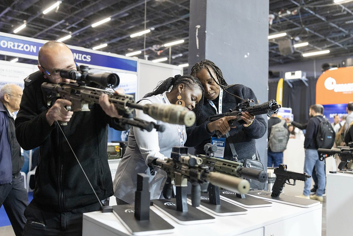 Attendees inspect Israeli-made firearms at the Defense Tech Expo in Tel Aviv, February 17, 2026. (Oren Ziv) Attendees inspect Israeli-made firearms at the Defense Tech Expo in Tel Aviv, February 17, 2026. (Oren Ziv)