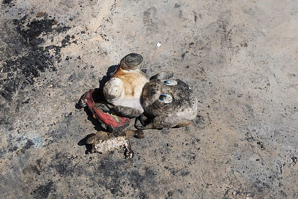 A burned children's toy following an Israeli settler pogrom in the Palestinian village of Tuba, Masafer Yatta, occupied West Bank, August 6, 2026. (Mosab Shawer/Activestills)