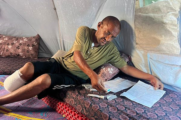 Dialysis patient Basel Al-Dahdouh in his family's tent on Al-Shuhada Street in central Gaza City, August 13, 2026. (Hussain Al-Jerjawi)